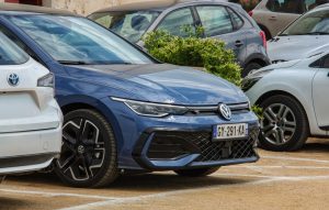 Blue volkswagen golf parked in a lot.